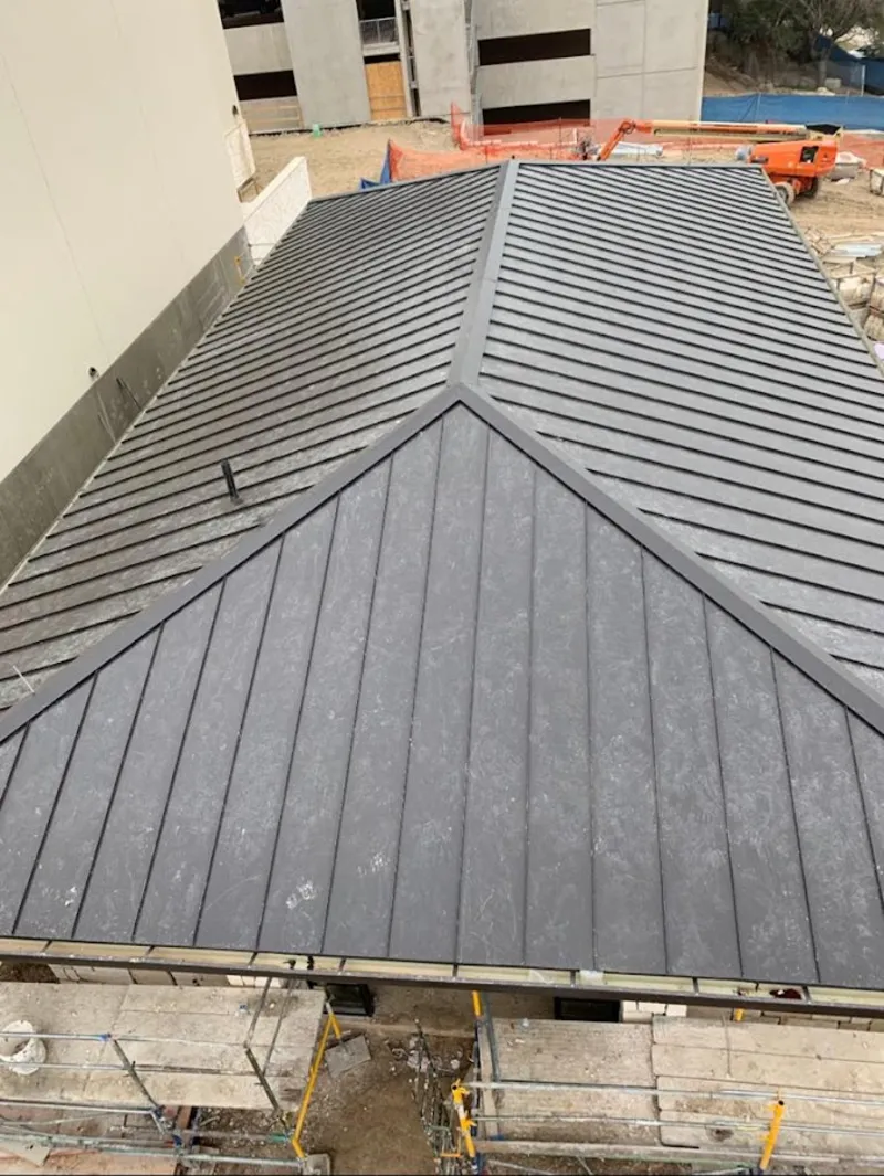 Commercial metal roof construction with crane equipment in Wappingers Falls